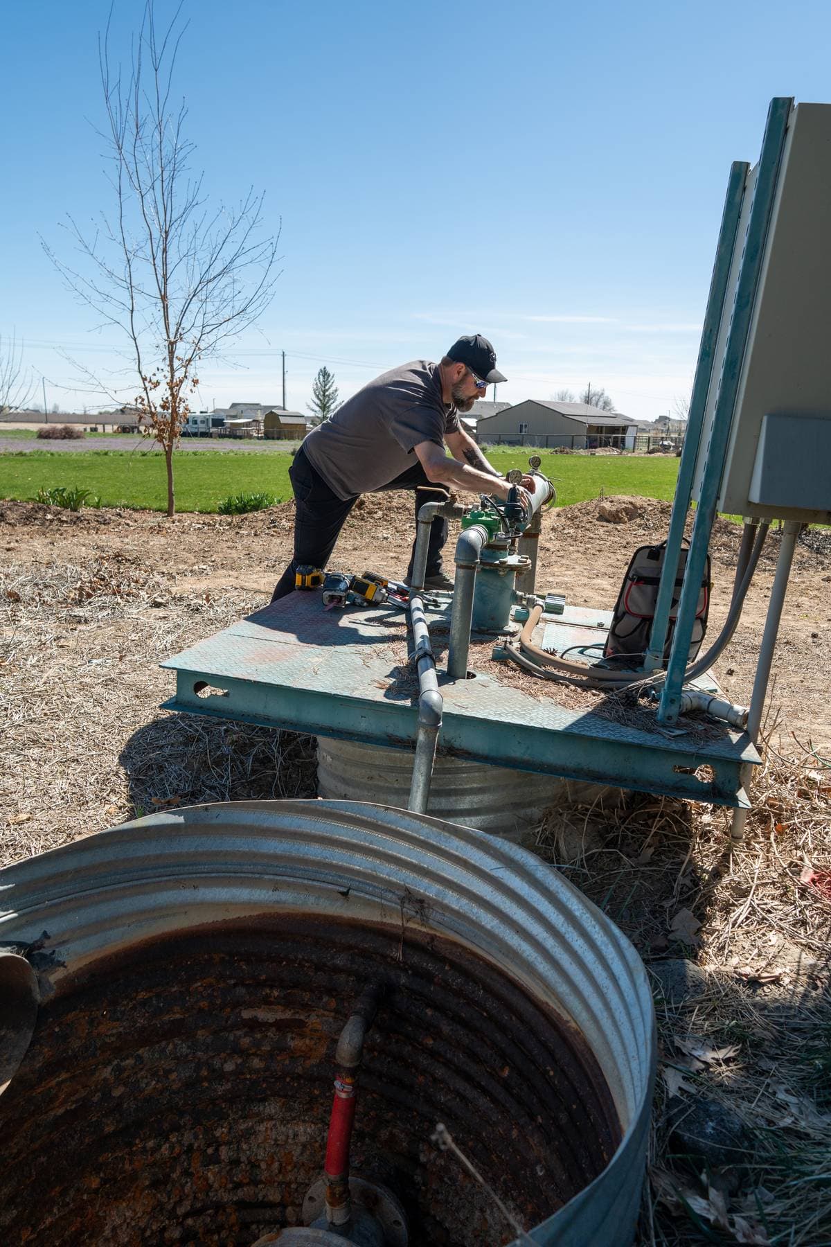 Technician working on a residential well pump system.